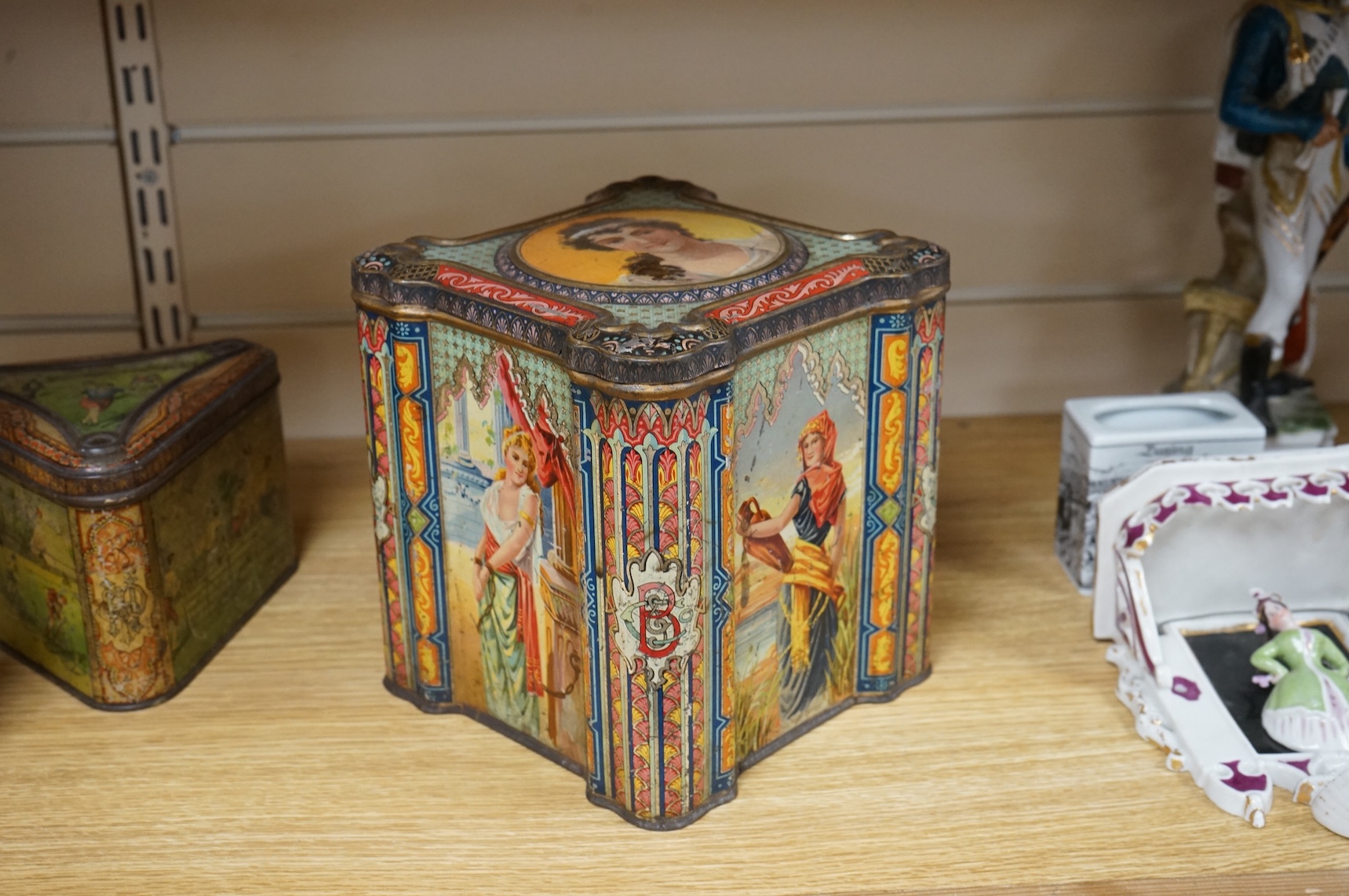A Windmill biscuit tin by Huntley & Palmer: Reading & London, 'BIVM' Eastern Beauties tea tin and Huntley & Palmers triangular biscuit tin with 'Sports' motifs